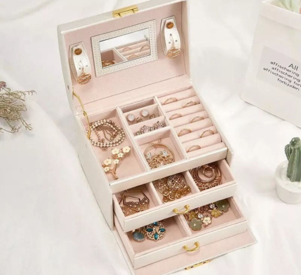 Elegant large-capacity jewelry box with PU leather exterior, velvet lining, built-in mirror, secure lock, and multiple storage compartments.