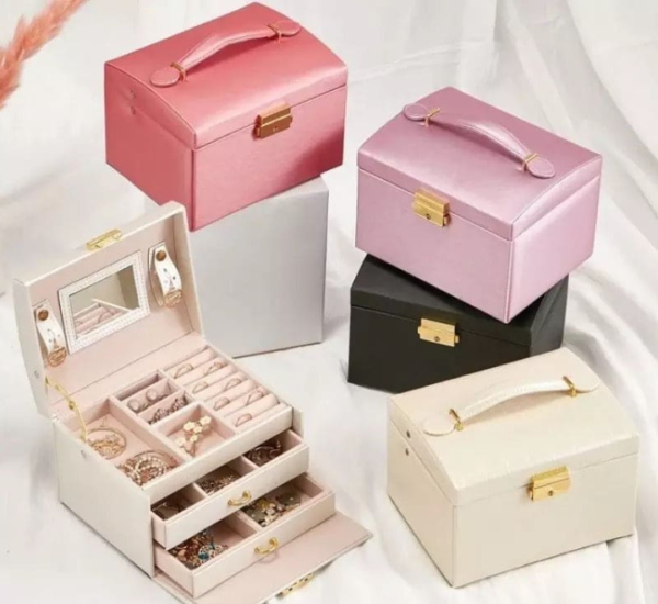 Elegant large-capacity jewelry box with PU leather exterior, velvet lining, built-in mirror, secure lock, and multiple storage compartments.