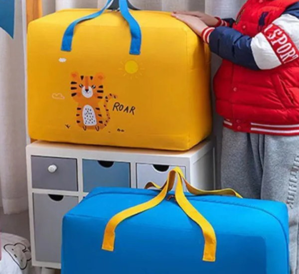 Durable canvas travel & storage bag with a cartoon print, zipper closure, and a sturdy nylon strap for easy carrying.